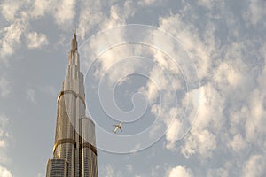 View of a Boing airplane flying close to Burj Khalifa in Dubai