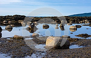 View of boulders above the water in a shallow tidal pool