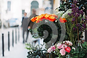 View of a bouquet of orange roses in a street flower shop in Paris