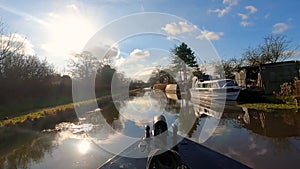 View from bow of narrowboat on a British canal in rural setting