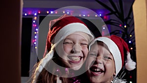 View from the box of funny children enjoying a gift from Santa Claus on Christmas evening