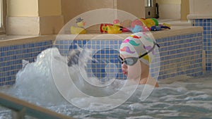 View of boy playing with toy in the kids swimming pool