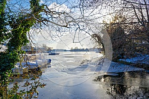 View through branches to the frozen Dahme river in Berlin Koepenick photo