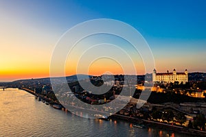 View of Bratislava castle, old town and the Danube river from observation deck bridge in Bratislava, Slovakia at night