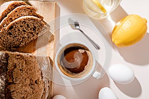 View of bread, eggs, lemon water