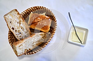 View of bread served in a basket and butter with a knife served before main meal