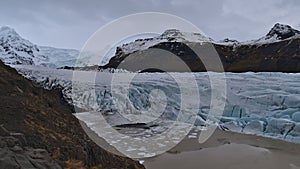 Breakoff edge of SvÃÂ­nafellsjÃÂ¶kull glacier, part of VatnajÃÂ¶kull ice cap in southern Iceland, with crevasses and glacial lake. photo