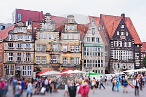 View of Bremen market square with Town Hall, Roland statue and crowd of people, historical center, Germany