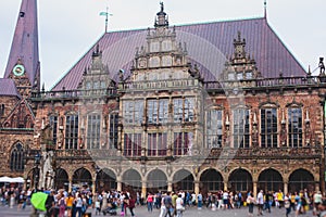 View of Bremen market square with Town Hall, Roland statue and crowd of people, historical center, Germany