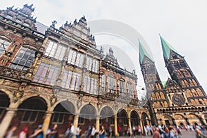 View of Bremen market square with Town Hall, Roland statue and crowd of people, historical center, Germany