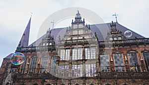 View of Bremen market square with Town Hall, Roland statue and crowd of people, historical center, Germany