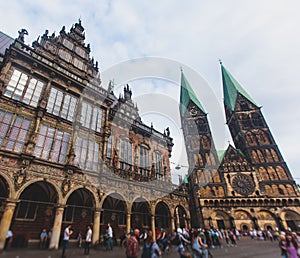 View of Bremen market square with Town Hall, Roland statue and crowd of people, historical center, Germany