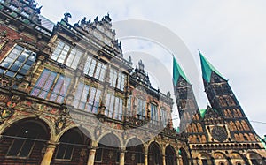 View of Bremen market square with Town Hall, Roland statue and crowd of people, historical center, Germany