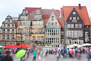 View of Bremen market square with Town Hall, Roland statue and crowd of people, historical center, Germany