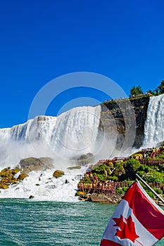 View on the Bridal Veil Falls and American Falls of the Niagara Falls and Canadian flag, the part of Goat Island, the