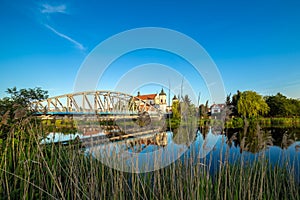 View at bridge over the Narew river and baroque Church of the Ho