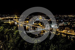 A view of the bridge over the River Danube from the foot of the Liberty Statue at night