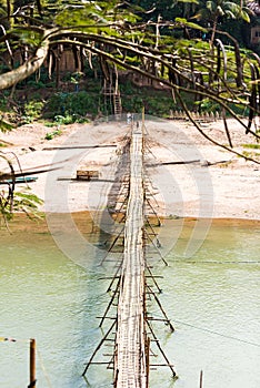 View of the bridge over the river Nam Khan river, Louangphabang, Laos. Copy space for text. Vertical.