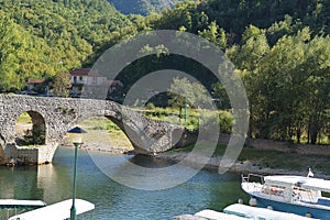 View of the bridge over the river with a round span, built of stone, an old building in Montenegro