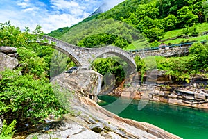 View of Bridge Ponte dei Salti to Verzasca River at Lavertezzo - clear and turquoise water stream and rocks in Ticino - Valle