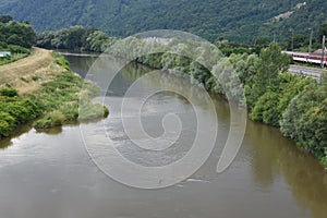 View from the bridge on sedimentary water of river Hron in Slovakia near town Zarnovica.