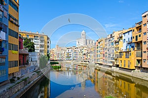 View of bridge of St. Augustine across river Onyar, Cathedral and buildings of city Girona, Spain