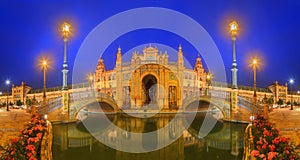 View of bridges and lights in Spain Square at evening, landmark in Renaissance Revival style, Seville, Andalusia, Spain