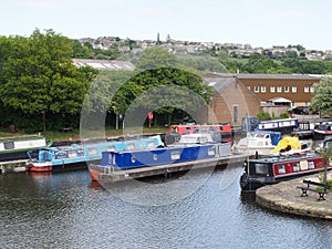 a view of brighouse basin boats and moorings on the calder and hebble navigation canal in calderdale west yorkshire