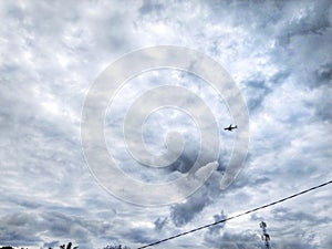 View of a bright blue sky with white clouds that look like cotton on top and
Airplane flying photo