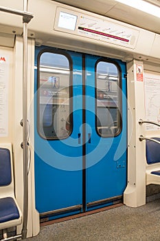 Contemporary inside space of the underground railway carriage with empty seats.