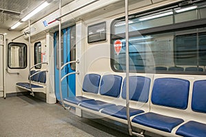 Contemporary inside space of the underground railway carriage with empty seats.