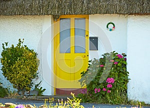 View of brightly Irish house front with traditional colored england entrance door.