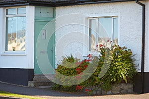 View of brightly Irish house front with traditional colored england entrance door.