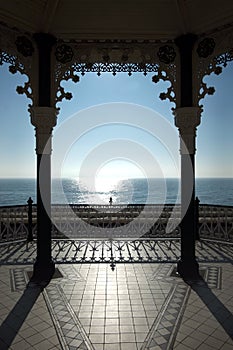 View of Brighton bandstand and the sun shining on a blue sea and blue sky, United Kingdom