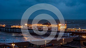 View of Brighton pier floodlit at night