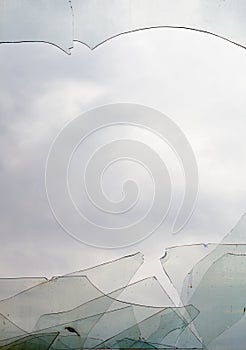 View through broken window at cloudy sky