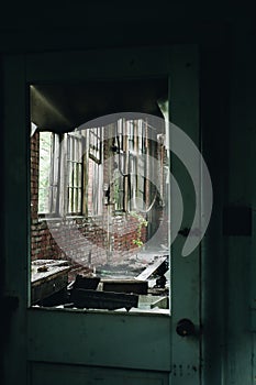 View Through Broken Window in Wood Door - Abandoned Republic Rubber Factory - Youngstown, Ohio