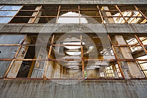 View through the broken windows of a demolished abandoned industrial building