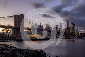 View of the Brooklyn Bridge and Manhattan from the riverside of the East River at sunset - 9