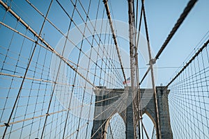 View of Brooklyn Bridge in New York City, USA, on a sunny winter day against blue sky
