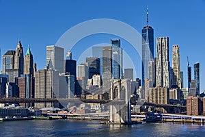 A view of Brooklyn bridge with the skyscrapers of Lower Manhattan and the World Trade Center in the background on a clear