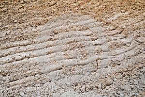 View of brown cracked natural moist earth clay. The background. Texture