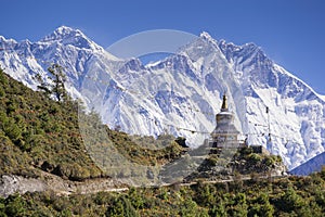 View of a Buddhist stupa with mountain Lhotse and Ama Dablam behind on the way from Namche Bazaar to Tengboche. photo