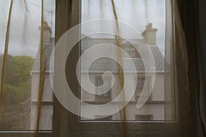 View of a building through curtained windows