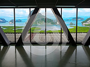 View from building window of landscape mangrove forest, mountain and sea with blue sky white cloud. Travel concept