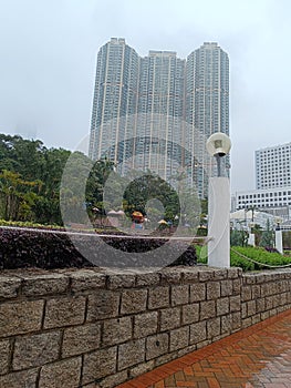 View of buildings and plants in Kowloon park, Hong Kong during rain