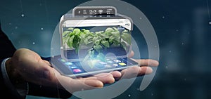 Businesmann holding a Digital vegetal plant connected