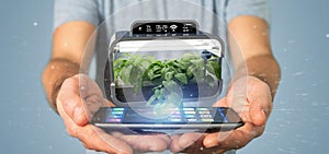 Businesmann holding a Digital vegetal plant connected photo