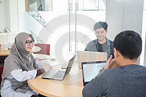 View of business people discussing in meeting room at creative office