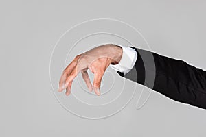 View of businessman grabbing hand isolated on grey